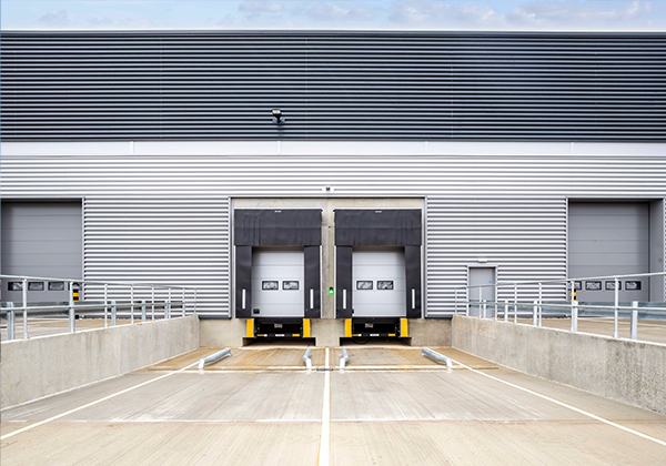 A typically loading bay, supplied dock leveller, shelter, dock dock and wheel guides. OH1042P level access doors either side Gallery Image