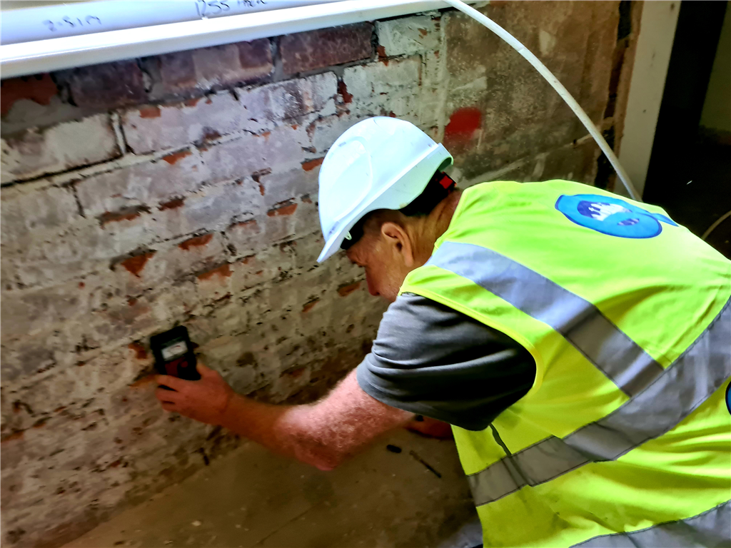 carrying out moisture level survey on school building Gallery Image