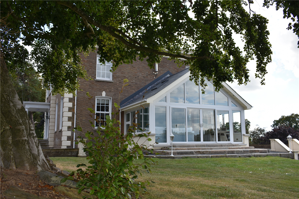 Modern sunroom extension with sliding patio doors Gallery Image